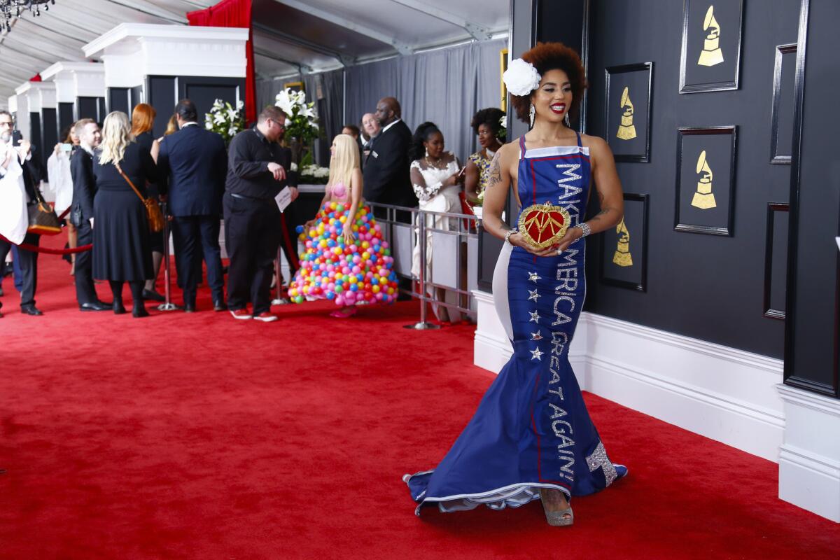 Joy Villa wears a "Make America Great Again" dress, while Girl Crush dons a plastic ball outfit, at the Grammys.