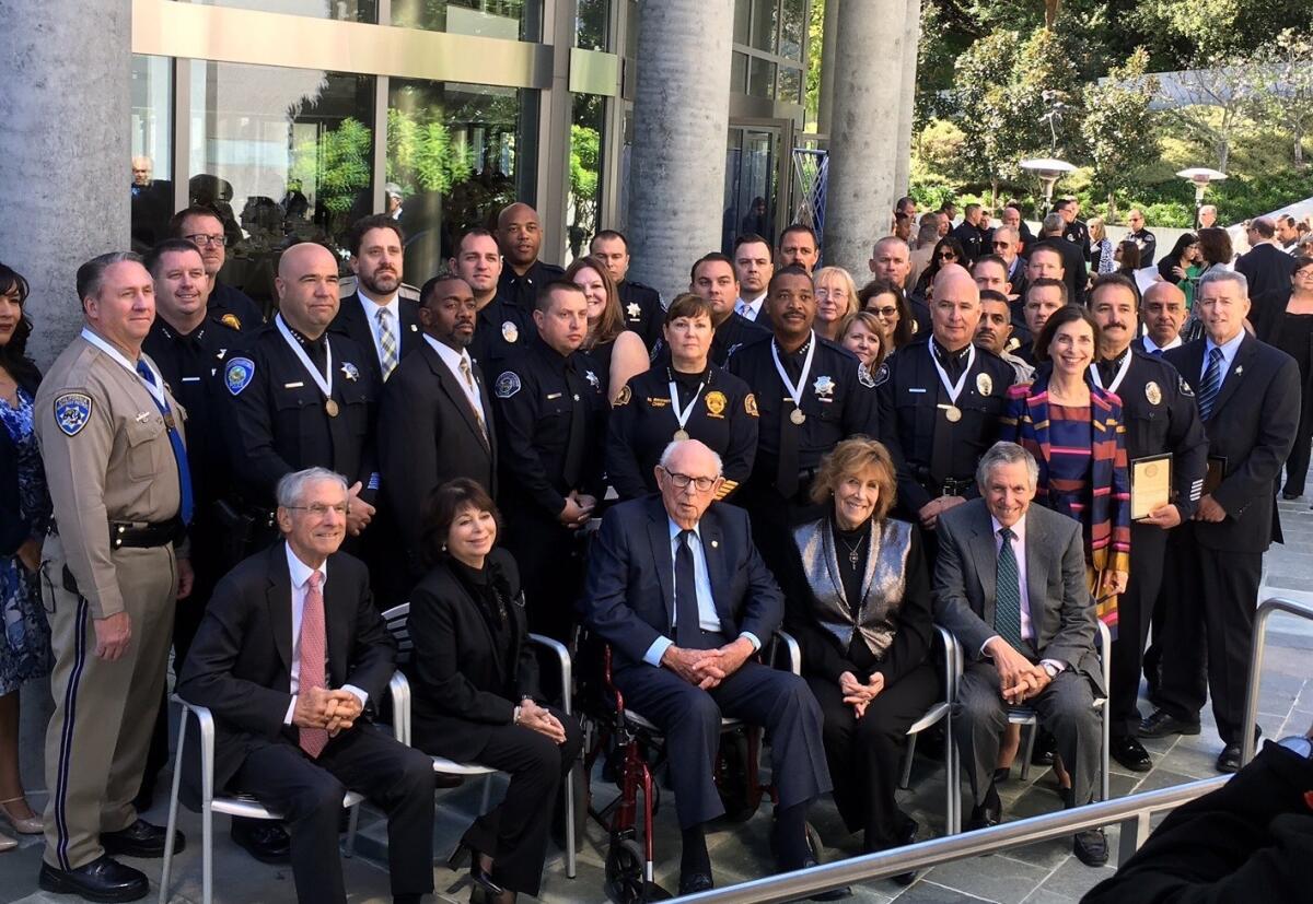 Joseph Sherwood, seated at center, is surrounded by his family and the investigators and first responders from the San Bernardino terror attack.