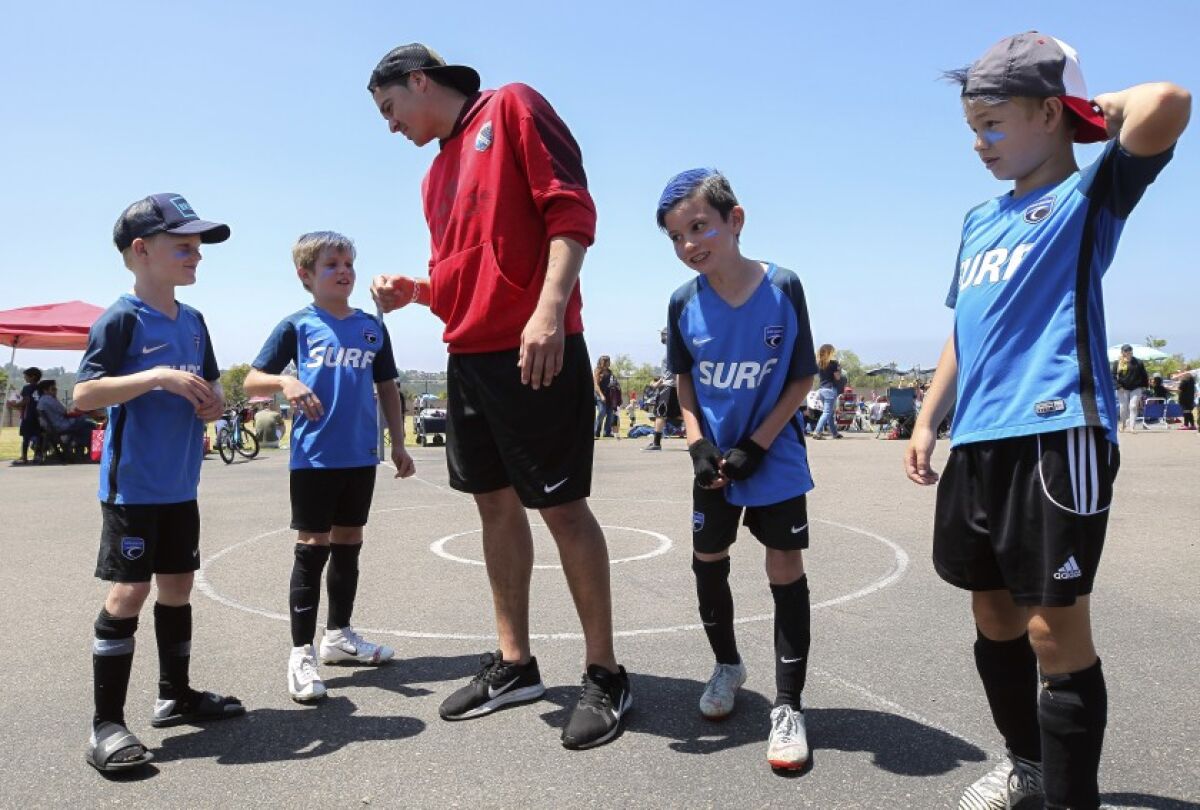 San Diego Sockers goalie Boris Pardo talks to members of The Blues soccer team during the “Goals for Lives” soccer tournament at Sycamore Ridge Elementary in Carmel Valley on June 8. The event raised money to help find a cure for a rare cancer that targets children.