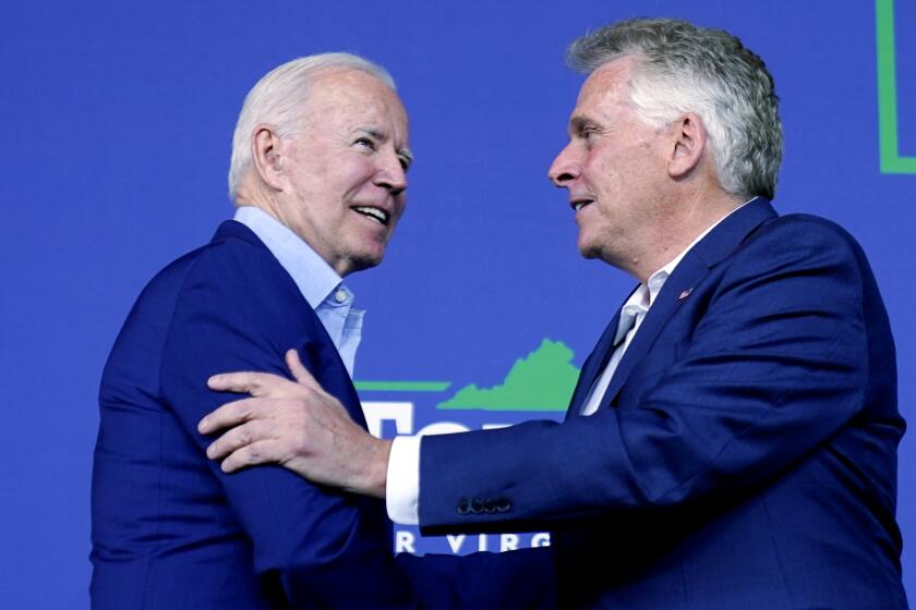 FILE - In this July 23, 2021 file photo, President Joe Biden greets Virginia democratic gubernatorial candidate Terry McAuliffe as he arrives to speak at a campaign event for McAuliffe at Lubber Run Park in Arlington, Va. Biden is heading across the Potomac River to campaign for Democrat Terry McAuliffe in a Virginia governor’s race that looks to be neck-in-neck just a week before Election Day. (AP Photo/Andrew Harnik)