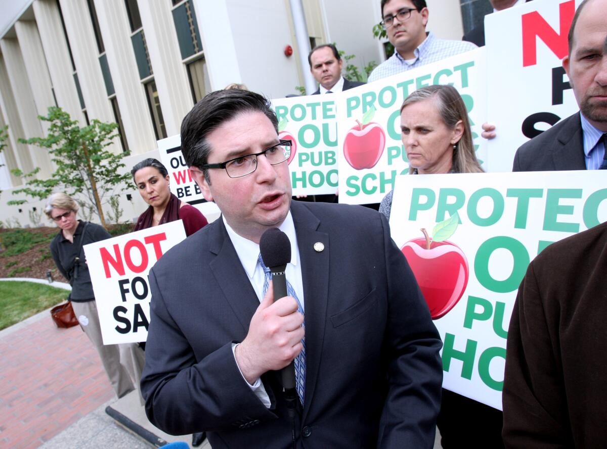 State Assembly District 43 candidate Ardy Kassakhian, center, speaks during a news conference at Glendale City Hall to denounce what he characterized as a negative campaign against him being funded on behalf of candidate Laura Friedman. Kassakhian is the Glendale city clerk and Friedman is a member of the City Council.