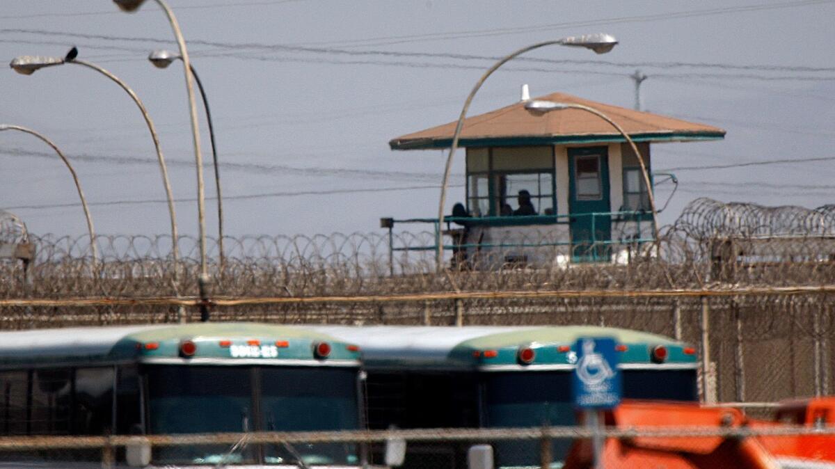 Prison employees keep watch from a guard tower at the California Institution for Men in Chino.