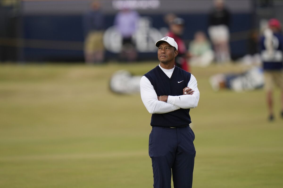Tiger Woods of the US waits to play on the 11th tee during the first round of the British Open golf championship on the Old Course at St. Andrews, Scotland, Thursday July 14, 2022. The Open Championship returns to the home of golf on July 14-17, 2022, to celebrate the 150th edition of the sport's oldest championship, which dates to 1860 and was first played at St. Andrews in 1873. (AP Photo/Alastair Grant)