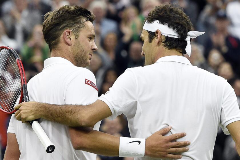 Marcus Willis, left, at the net with Roger Federer after their second round match at the Wimbledon Championships on Wednesday.