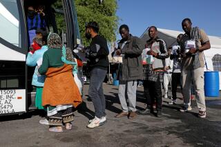 SOMERTON, AZ - MAY 12: Migrants who have been processed by U.S Border Patrol and have been released from their center, are given assistance from the Regional Center for Border Health to relocate to areas outside of Yuma, on Friday, May 12, 2023 in Somerton, AZ. Roughly 800 migrants were assisted today by the Regional Center for Border Health. Title 42, a pandemic-era policy that allowed border agents to quickly turn back migrants, expires this week. Under a new rule, the U.S. on Thursday will begin denying asylum to migrants who show up at the U.S.-Mexico border without first applying online using the CBP One mobile application or seeking protection in a country they passed through. (Gary Coronado / Los Angeles Times)