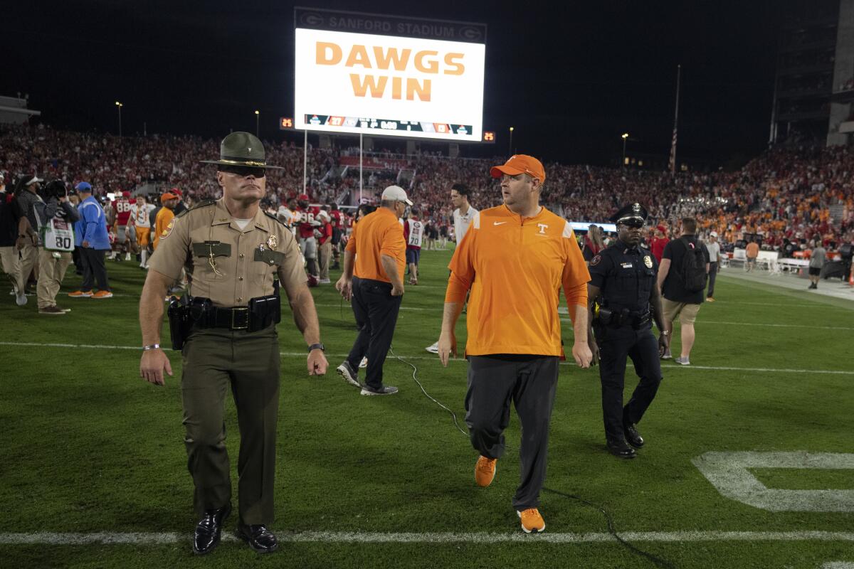 Tennessee coach Josh Heupel walks off the field after losing to Georgia 