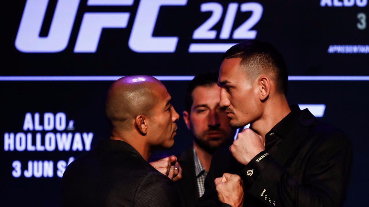 “I always wanted to be great, to stick out like a sore thumb, and I’m here doing it," says Max Holloway, right, shown facing off with UFC featherweight champion Jose Aldo, his opponent Saturday.