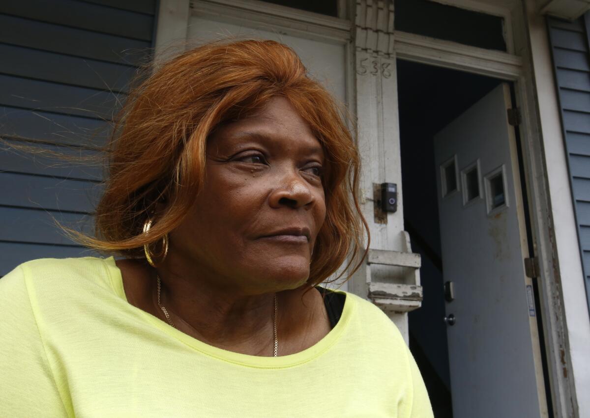 Dianne Green sits on the porch of her home in Chicago on Wednesday, March 24, 2021. Green, a retiree and cancer survivor, said she struggled with loneliness after several family members died in 2019 and early 2020. Then the pandemic hit. She credits a "friendly caller" from Rush University Medical Center with pulling her out of the depths of despair. Even before the pandemic, a survey found that 61 percent of American adults said they were lonely. A year of added isolation highlighted a problem that health officials say is as harmful as obesity and smoking. (AP Photo/Martha Irvine)