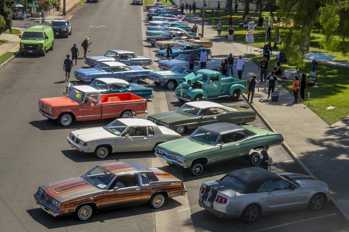 Cruising classic cars park on 10th Street in Santa Ana as part of the Chicano Heritage Festival.