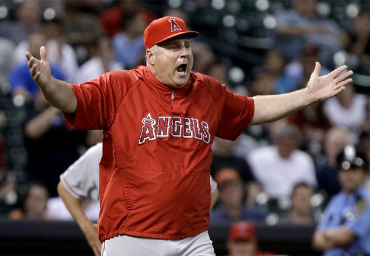 Angels Manager Mike Scioscia questions the umpires on a Houston Astros pitching change.