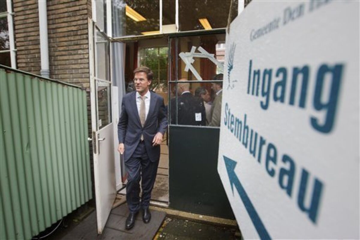 Conservative VVD party leader Mark Rutte, leading in opinion surveys on a deficit-busting, tough-on-immigration platform, leaves the polling station after casting his ballot in general elections in The Hague, Netherlands, Wednesday, June 9, 2010. Voters go to the polls in election offering a choice between a Labor Party preaching traditional Dutch tolerance and a slew of right-leaning parties advocating a crackdown on immigration. The free-market VVD party leads polls thanks to its strong economic credentials, the anti-Islam Freedom Party and its leader Geert Wilders also hope to book large gains. (AP Photo/Evert-Jan Daniels)
