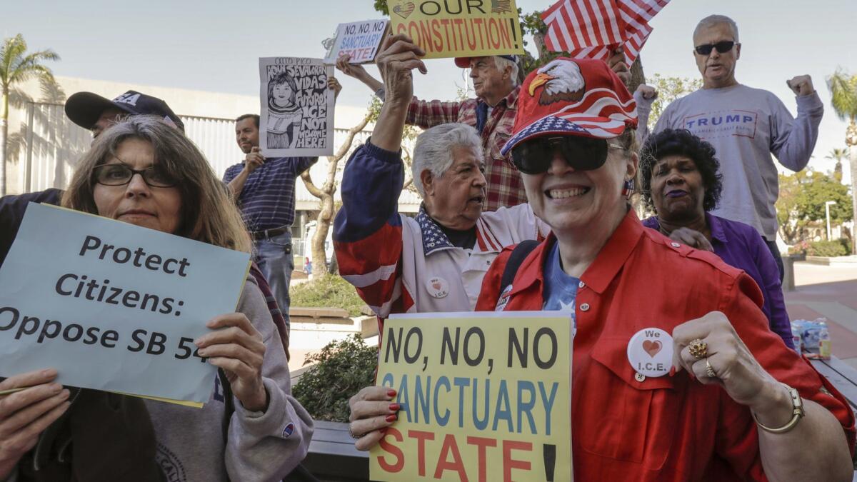 People opposing SB-54 celebrate. The Orange County Board of Supervisors approved a resolution to condemn the state's sanctuary laws.