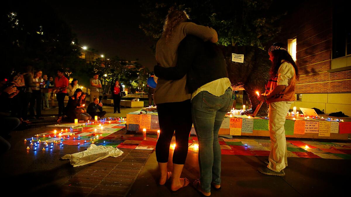 UCLA students hold a vigil as the community mourns the sudden and tragic deaths of two people on campus.