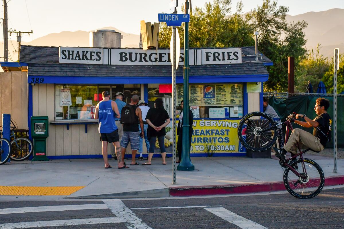 Customers lined up outside a burger shack