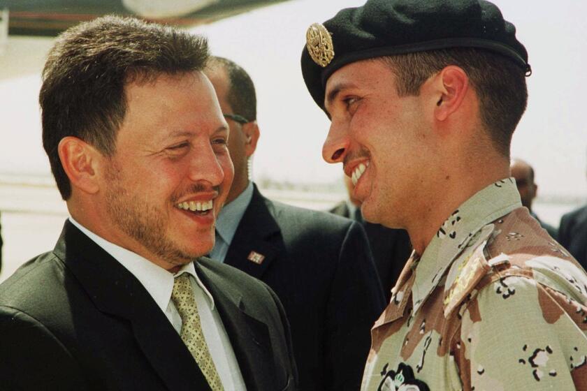 FILE - In this April 2, 2001, file photo, Jordan’s King Abdullah II laughs with his half brother Prince Hamzah, right, shortly before the monarch embarked on a tour of the United States. Prince Hamzah said in a recording released Monday, April 5, that he will defy government threats ordering him to stay at home and refrain from public statements following accusations he was behind a plot to destabilize the kingdom. (AP Photo/Yousef Allan, File)