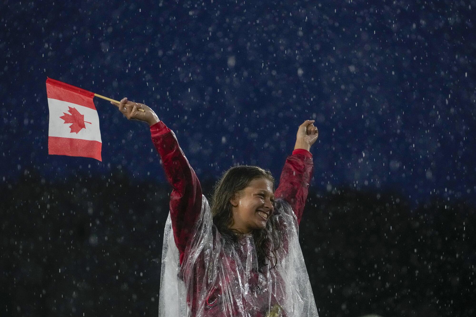 A Canadian athlete reacts while participating in the opening ceremony of the 2024 Summer Olympics.