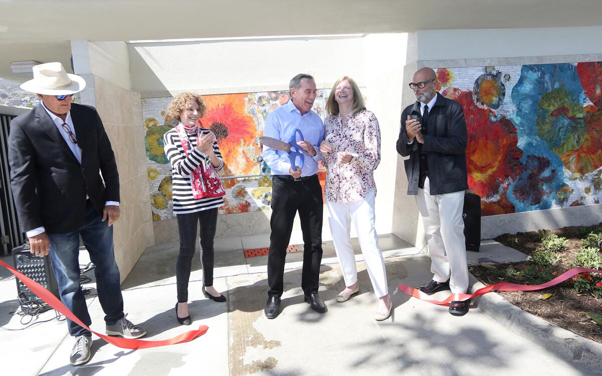 Laguna Beach City Council gathers to officially open the renovated South Main Beach restroom with a ribbon-cutting ceremony.