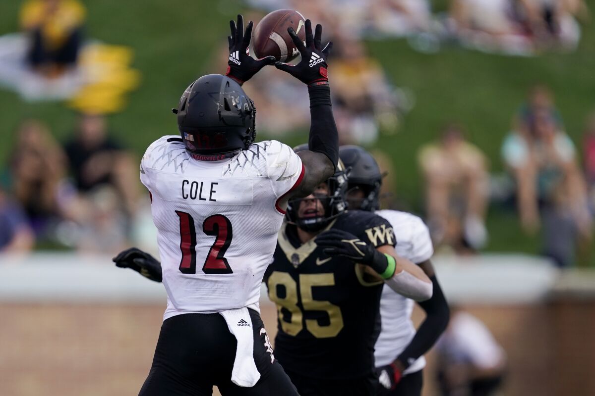 Louisville defensive back Qwynnterrio Cole intercept a passes intended for Wake Forest tight end Blake Whiteheart during the second half of an NCAA college football game on Saturday, Oct. 2, 2021, in Winston-Salem, N.C. (AP Photo/Chris Carlson)