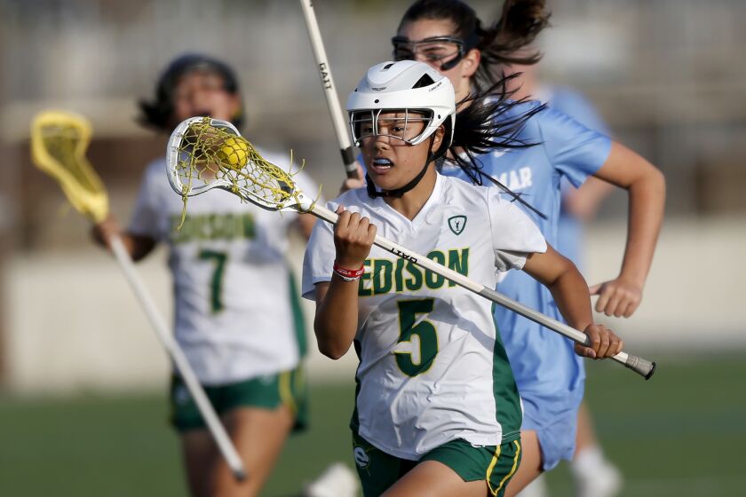 EdisonOs Sophia Chock makes a run for the goal during the girlsO Sunset League lacrosse finale against Corona Del Mar on Tuesday.