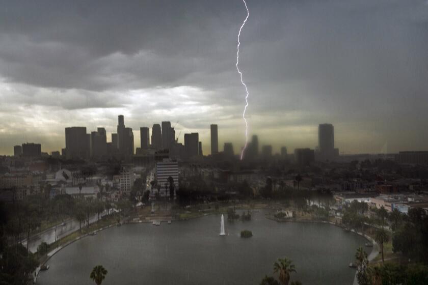 Lightning splits the sky over downtown Los Angeles July 18, 2015. More storms could be ahead in the coming days.