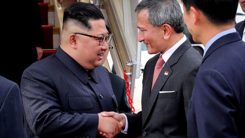 North Korean leader Kim Jong Un is welcomed by Singapore's Foreign Minister Vivian Balakrishnan, right, upon his arrival Sunday.