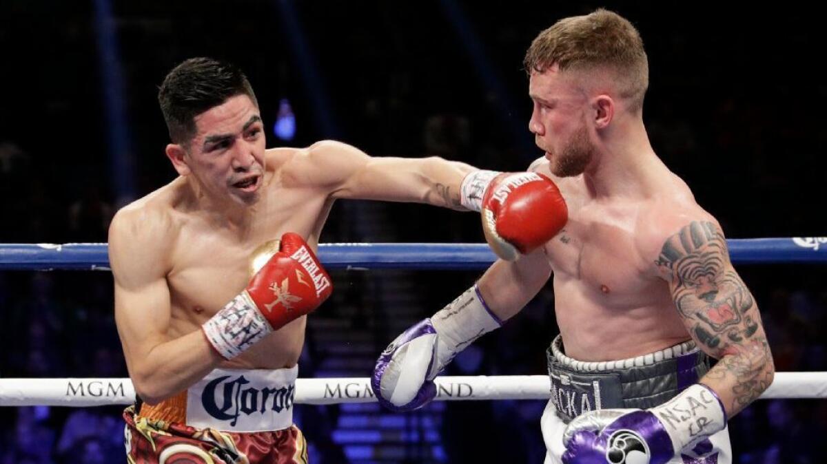 Leo Santa Cruz throws a left hand at Carl Frampton during their featherweight title bout in Las Vegas on Jan. 28.