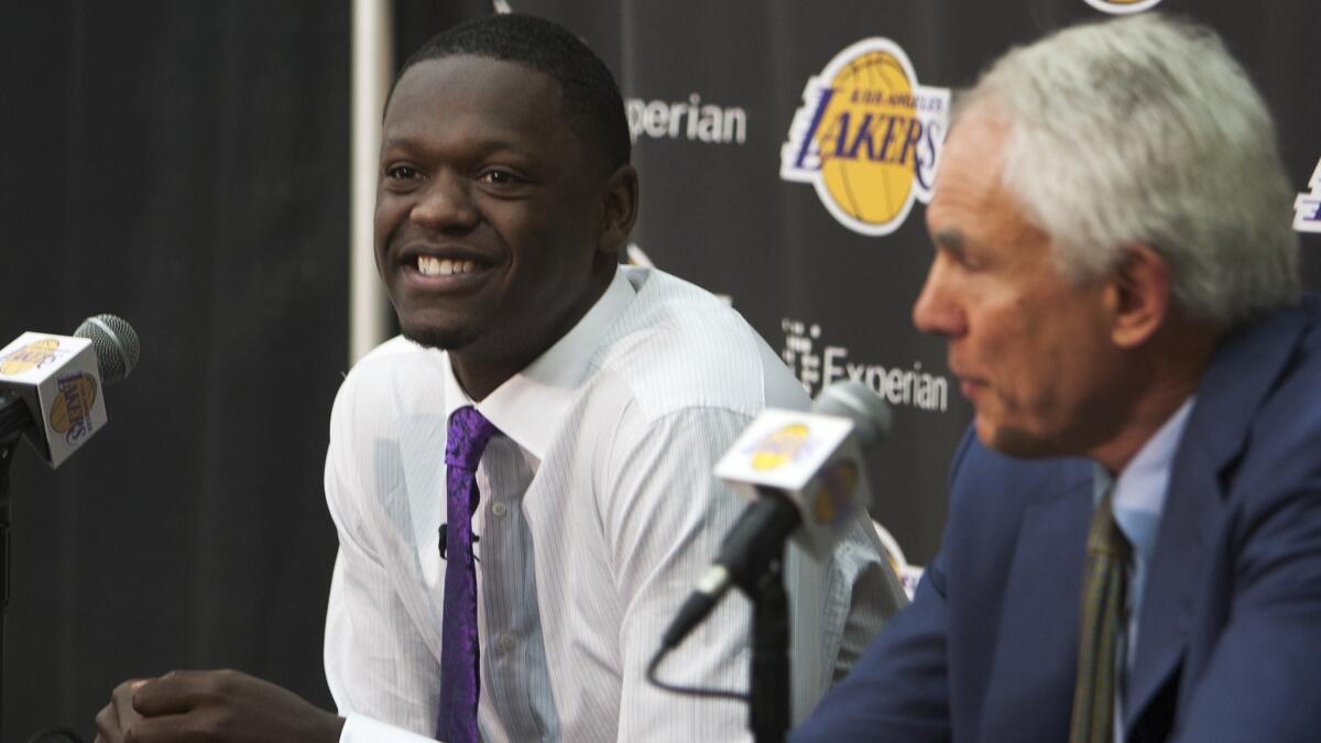 Lakers first-round draft selection Julius Randle smiles while sitting next to General Manager Mitch Kupchak during a news conference in El Segundo on Monday. Randle does not need to undergo surgery on his right foot.