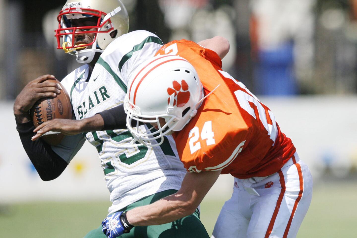 Blair's Sherman Simpson, left, gets tackled by Pasadena Poly's Jake Zelek during a game at Pasadena Poly on Saturday, September 8, 2012.