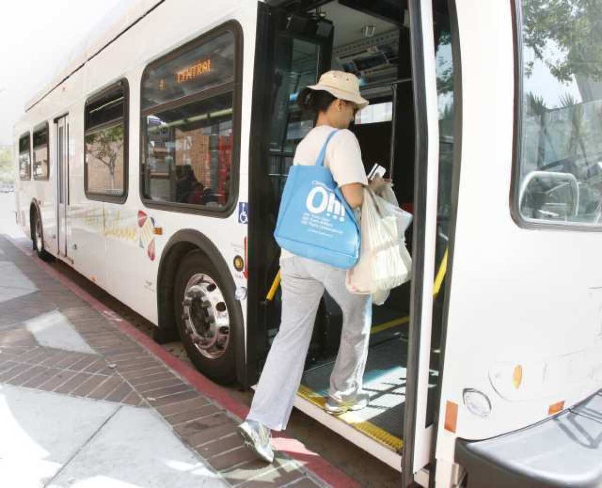 A woman gets on a Glendale Beeline bus on Brand Boulevard near Broadway.