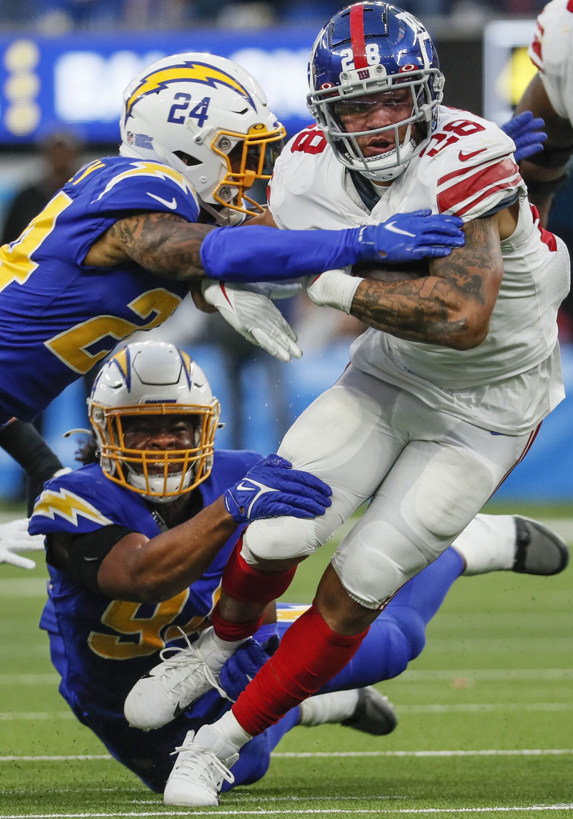 New York Giants running back Devontae Booker eludes Chargers tacklers on a second-half run.