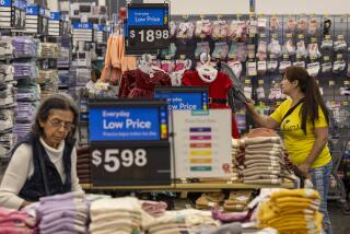 Burbank, CA - November 14: Shoppers look over clothing items at the Walmart Supercenter on Tuesday, Nov. 14, 2023 in Burbank, CA. (Brian van der Brug / Los Angeles Times)