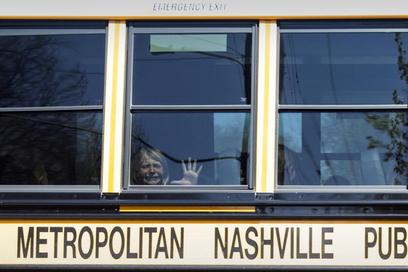 FILE - A child weeps while on the bus leaving The Covenant School following a mass shooting at the school in Nashville, Tenn., Monday, March 27, 2023. A 28-year-old killed three children and three adults in a shooting at a small Christian elementary school before being killed by police. The shooter was a former student there. Police have said the shooter “was assigned female at birth” but used masculine pronouns on social media. (Nicole Hester/The Tennessean via AP, File)