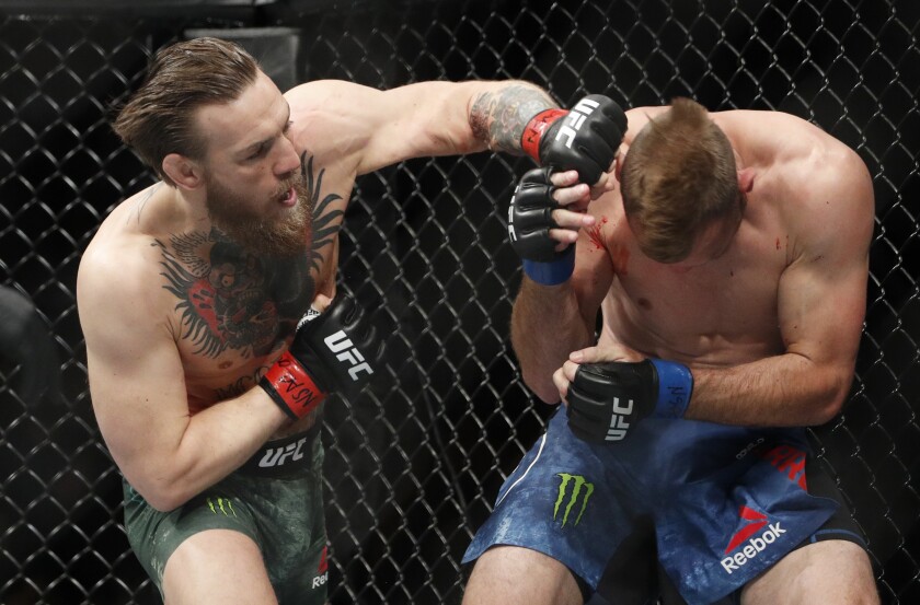 Conor McGregor delivers an overhand left against Donald "Cowboy" Cerrone only seconds into their UFC 246 fight on Jan. 18, 2020, in Las Vegas.