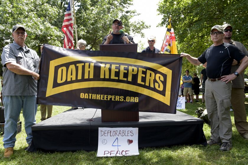 Stewart Rhodes, founder of the citizen militia group known as the Oath Keepers, center, speaks during a rally outside the White House in Washington, Sunday, June 25, 2017. Rhodes was one of many speakers at the "Rally Against Political Violence," that was to condemn the attack on Republican congressmen during their June 14 baseball practice in Virginia and the "depictions of gruesome displays of brutality against sitting U.S. national leaders." (AP Photo/Susan Walsh)