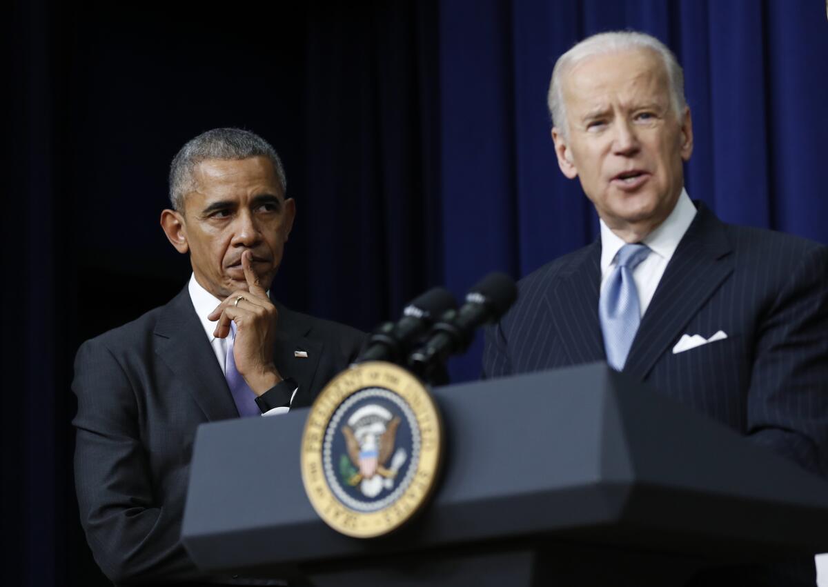Then-President Obama listens as Vice President Joe Biden speaks in the White House complex in December 2016.