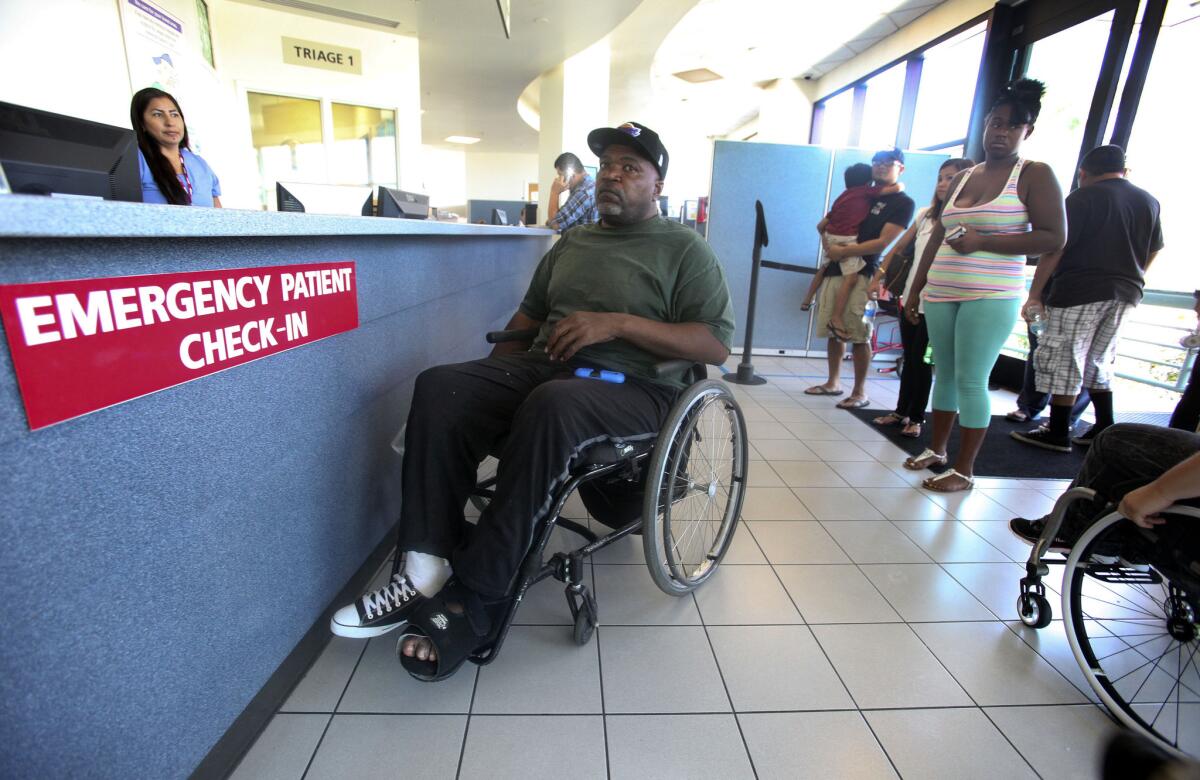 A patient waits for treatment at Long Beach Memorial Hospital's emergency room in August.
