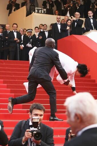 Security tackles an intruder on the red carpet at "The Beaver" screening.