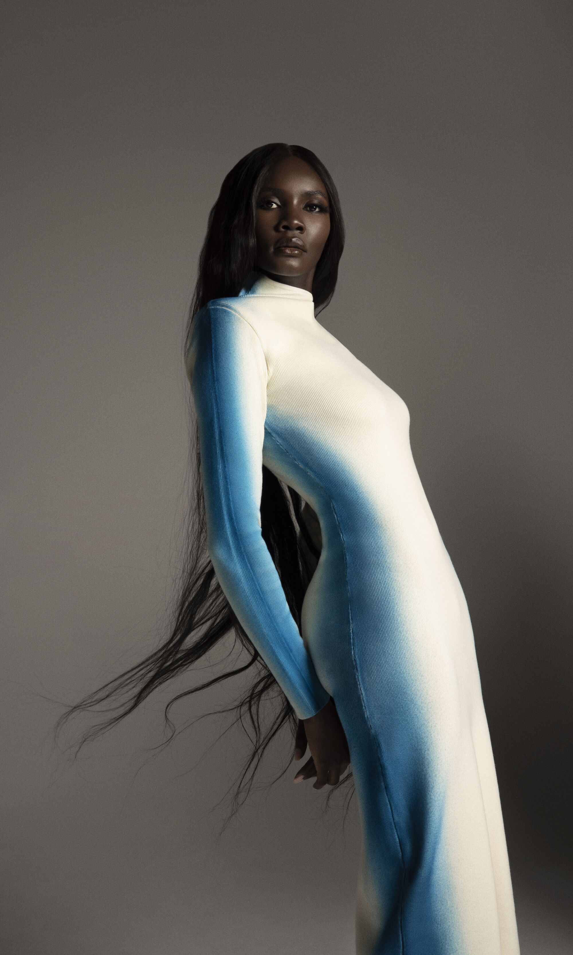 A model in a long, long-sleeve white dress
