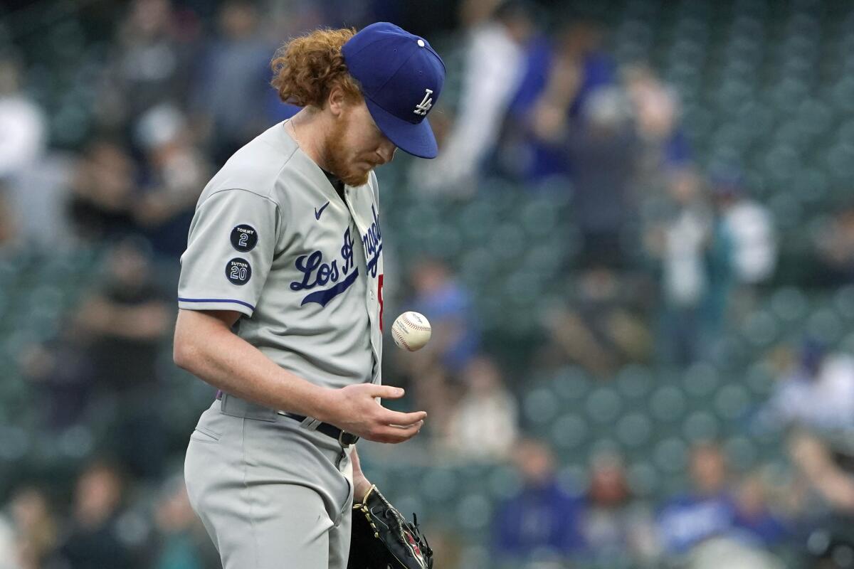 Los Angeles Dodgers starting pitcher Dustin May tosses the ball on the mound after he gave up a two-run home run.