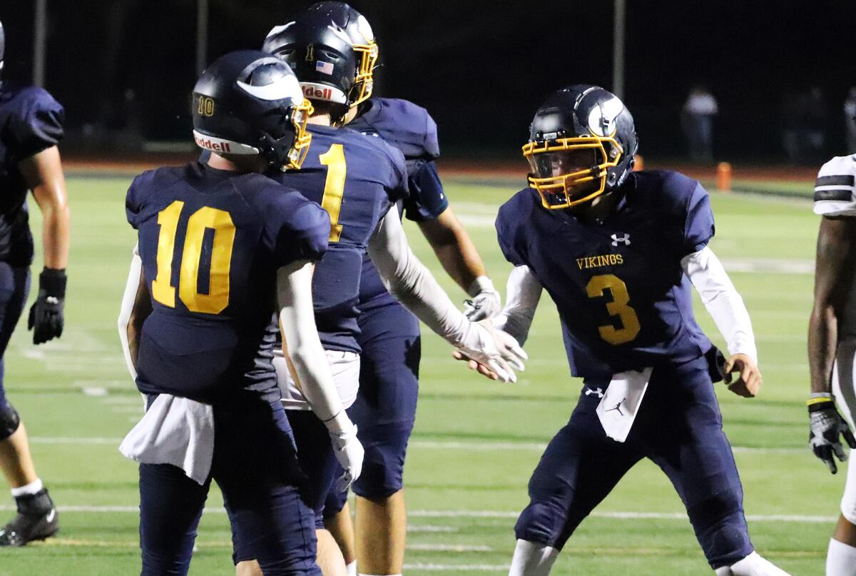 Marina's Ty Green (1) and Garrett Hunnicut (3) celebrate their first touchdown of the season against Sunny Hills on Friday.