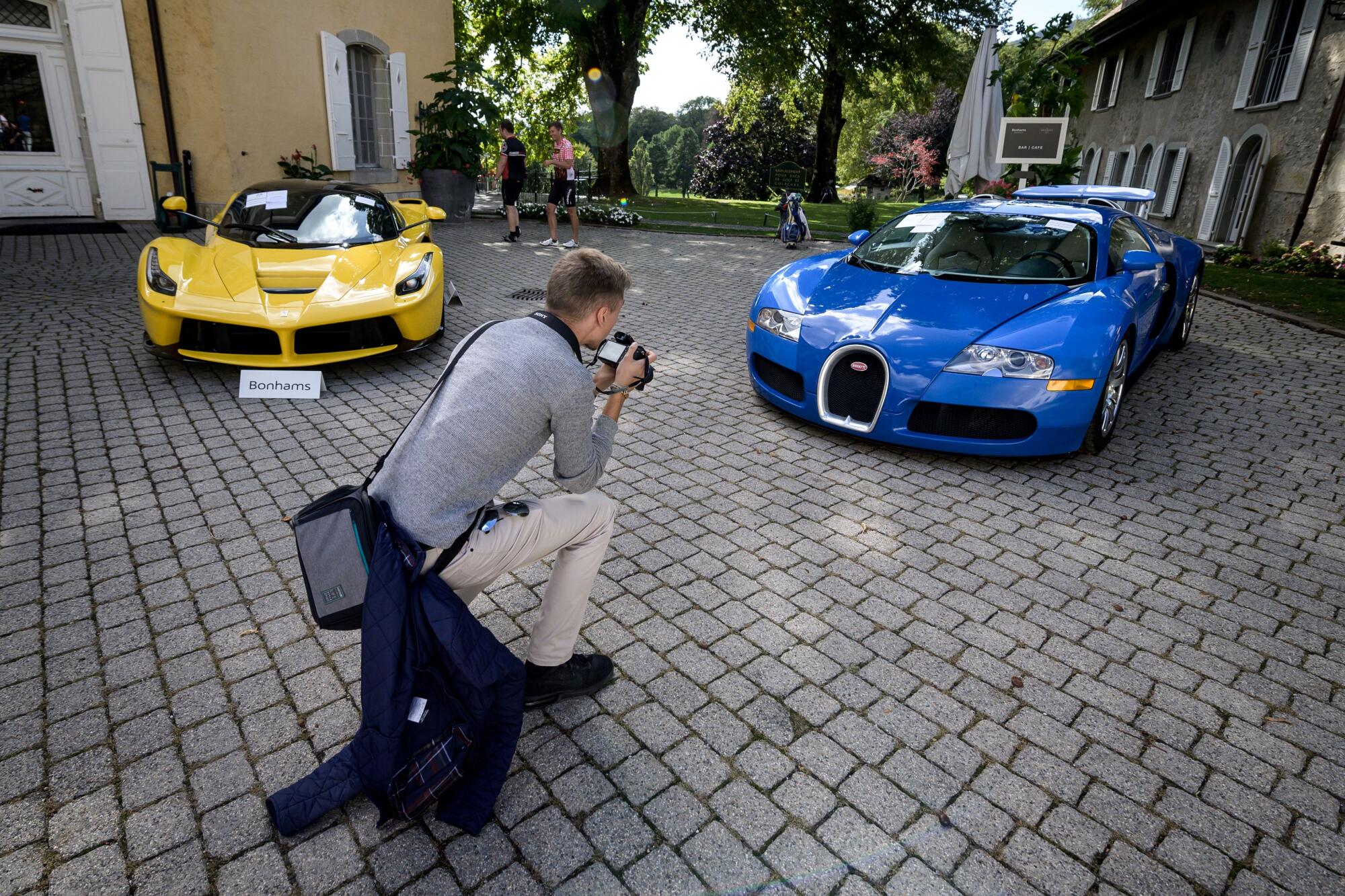 A 2015 Ferrari LaFerrari, left, and a 2010 Bugatti Veyron EB 16.4 Coupe