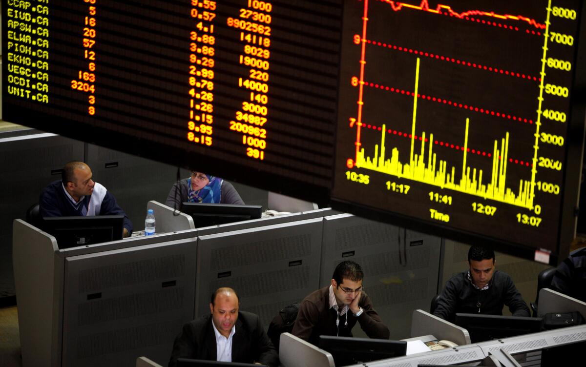 Egyptian traders work at the stock market in Cairo last year.