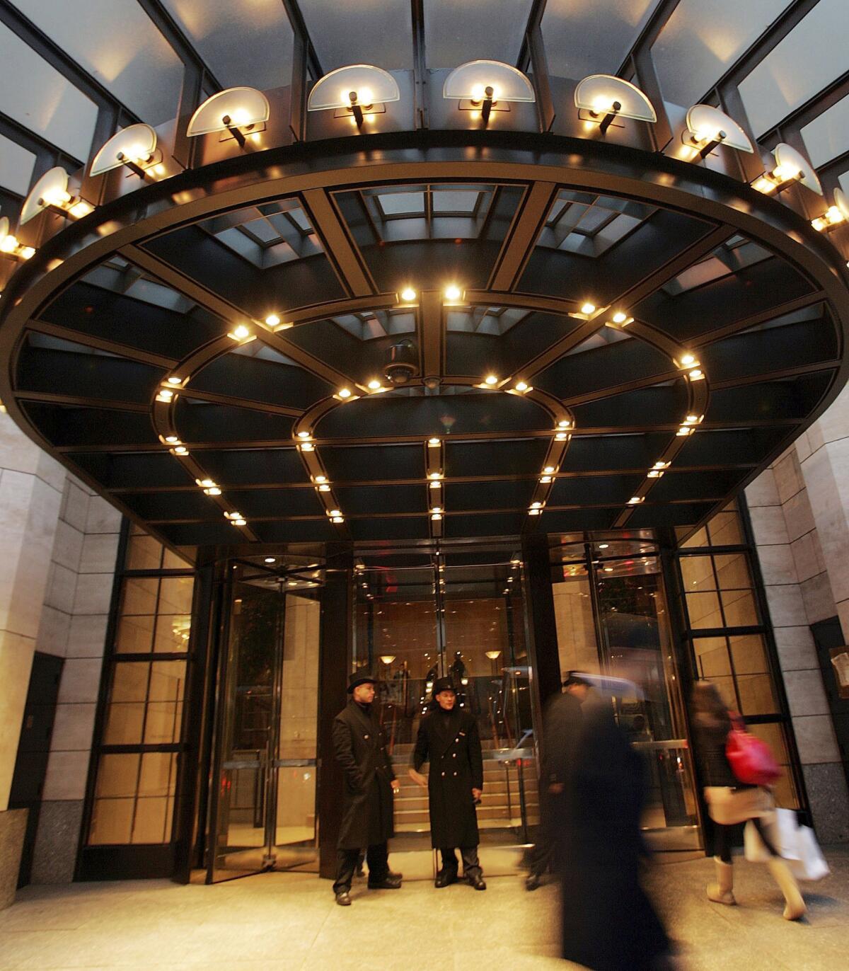 People walk by the Four Seasons Hotel in New York City.