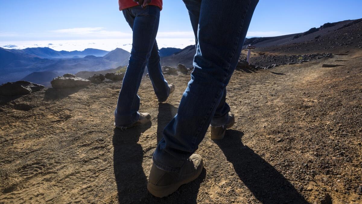 Those boots were made for walking as visitors hike a trail through Haleakala National Park on Maui.
