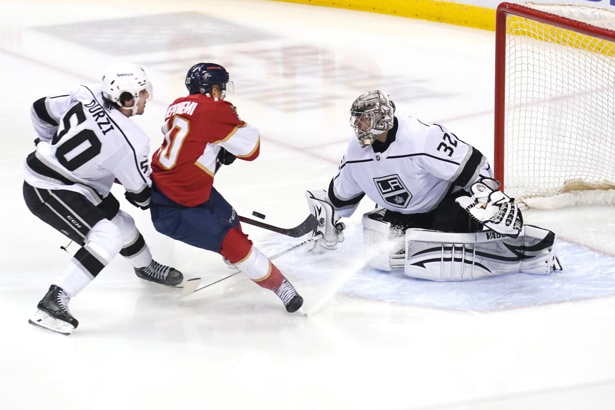 Kings goaltender Jonathan Quick deflects a shot on goal by Florida Panthers center Aleksi Heponiemi.