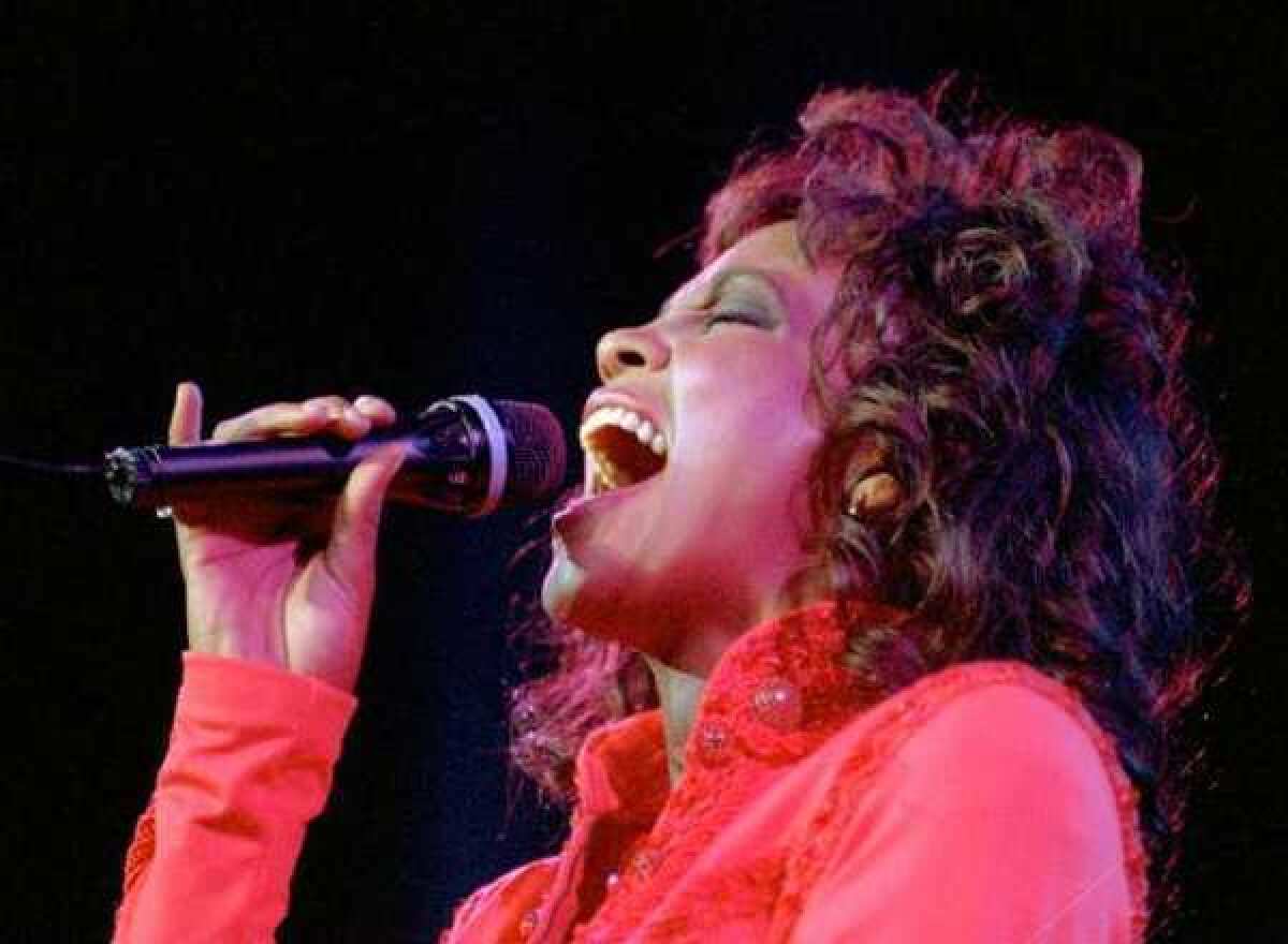 Whitney Houston performs in Anaheim in 1994. On Thursday, Los Angeles health officials said that the singer died in an accidental drowning. Cocaine and heart disease were also factors in her death.