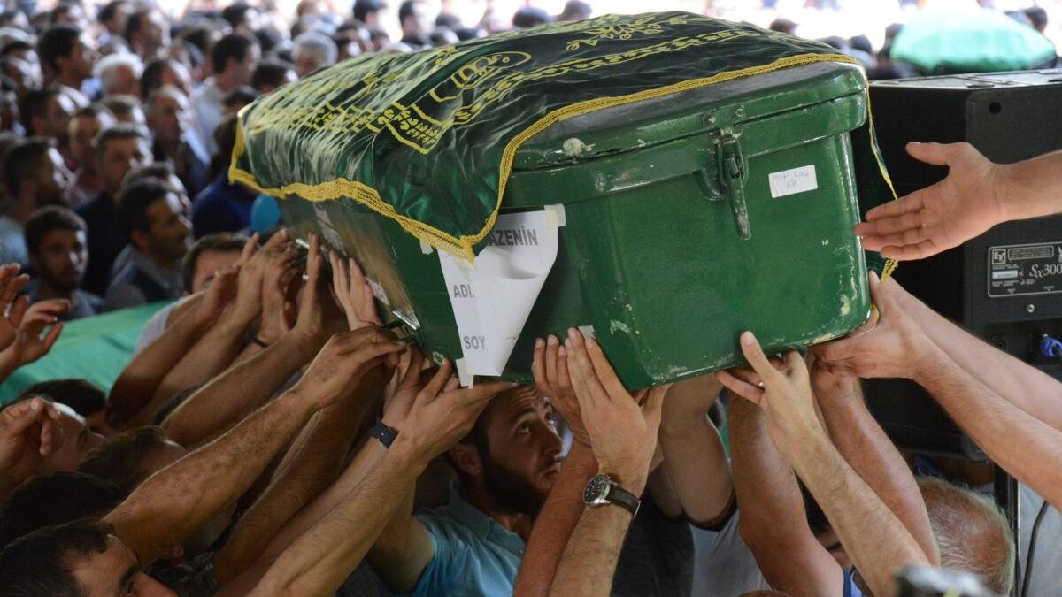 People carry the coffin of a bombing victim during a funeral Sunday, after an attack on a wedding party left at least 51 dead in Gaziantep, in southeastern Turkey, near the Syrian border.
