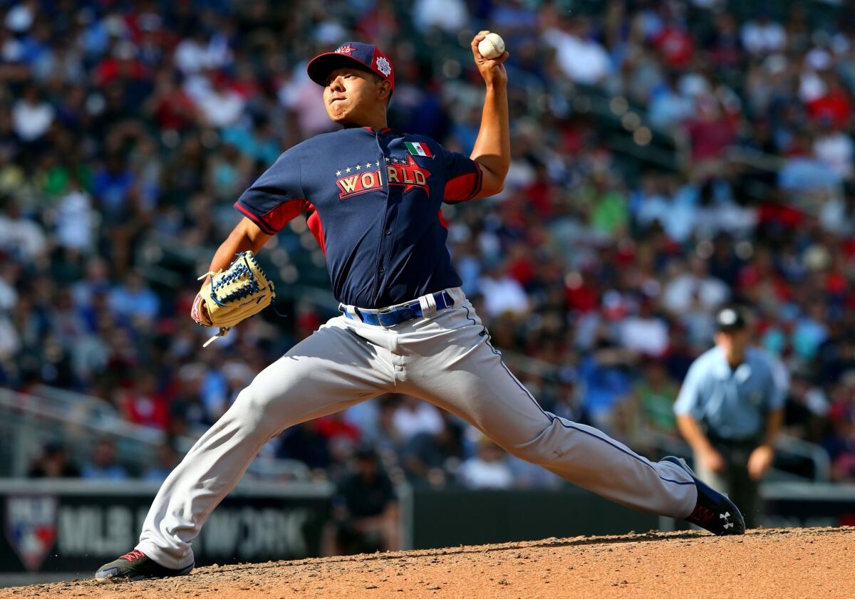 Julio Urias, shown pitching at the All-Star Futures game at Target Field on July 13, is still in the Dodgers organization after Thursday's trade deadline.