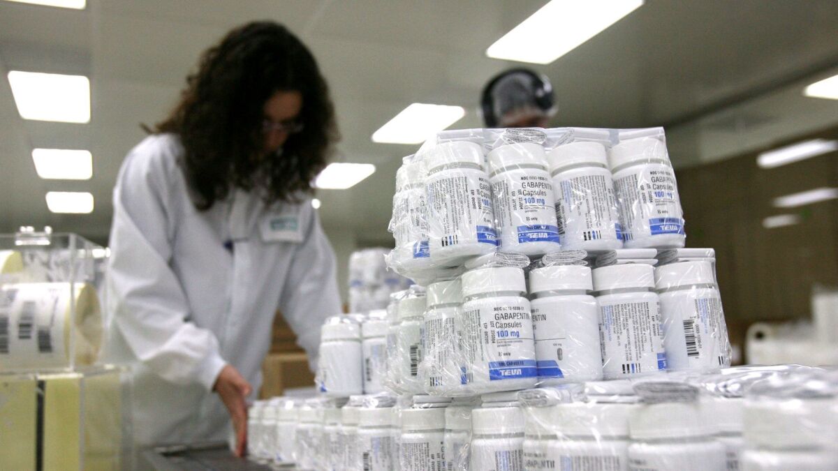 Teva employees pack drugs at a company plant in Jerusalem.
