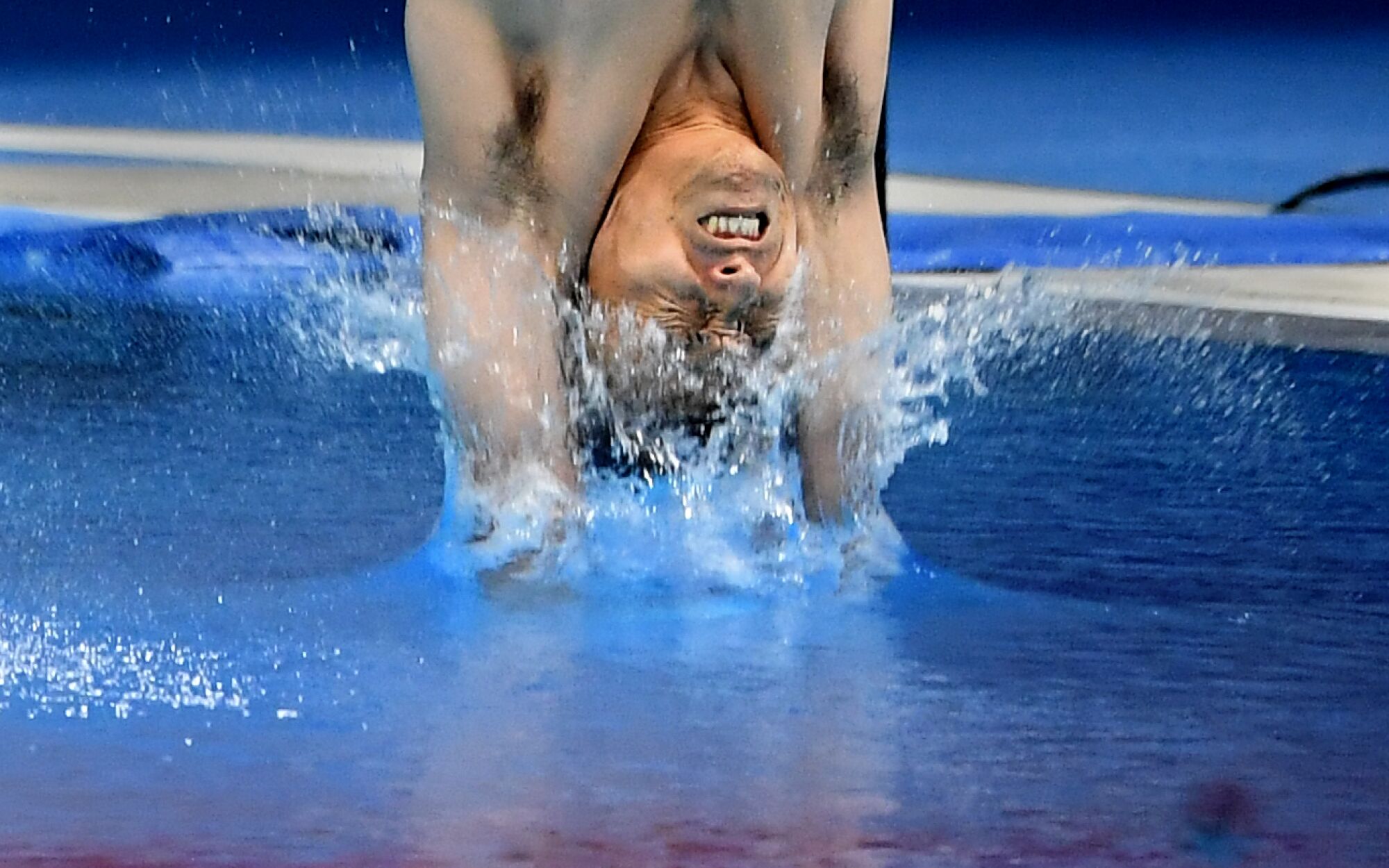 A member of Japan men's synchronized 3m springboard makes a dive